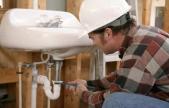 plumber fixing sink