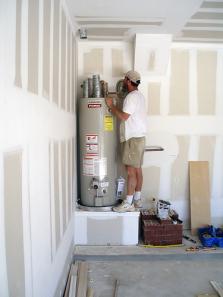Plumber in Shingle Springs CA checks a water heater during an installation job